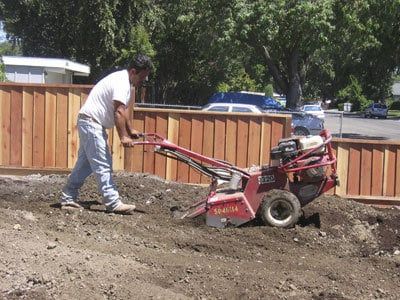 Man using a Machine to Dirt Roto-Till