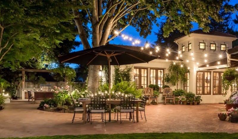 Patio Light Strings hung from House to the Tree to illuminate backyard patio area