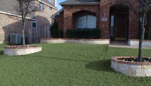 Chopped Stone Planter Beds with a Brick Top to match home