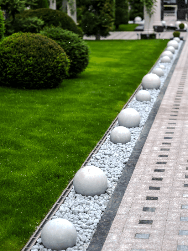 Landscape pathway created with pavers, pebble stones, and edging