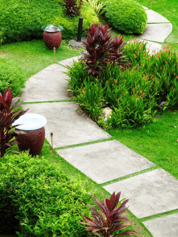 Pathway created out of sizeable square slate stones and plants installed for a beautiful landscape