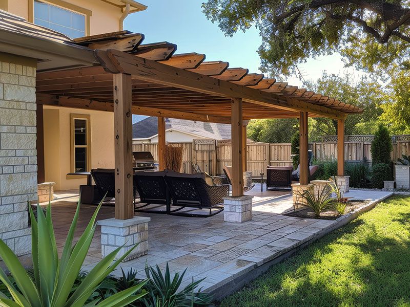 Stunning cedar pergola with elegant footer columns installed in a lush backyard garden
