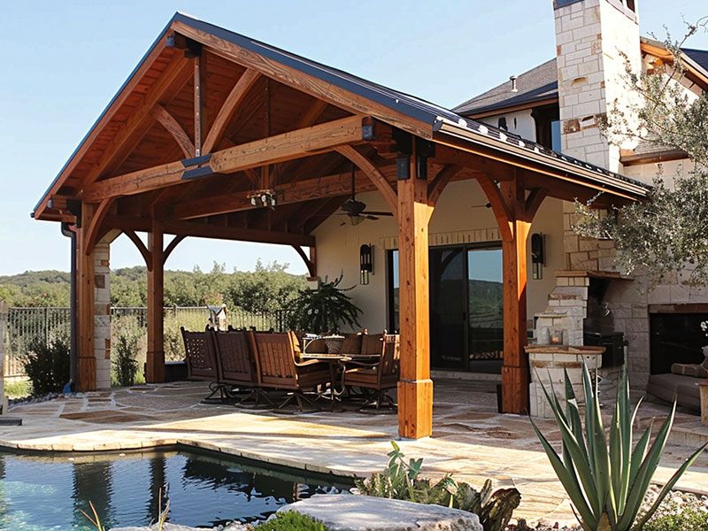 Custom cedar patio cover with durable metal roof providing stylish outdoor shade and weather protection.
