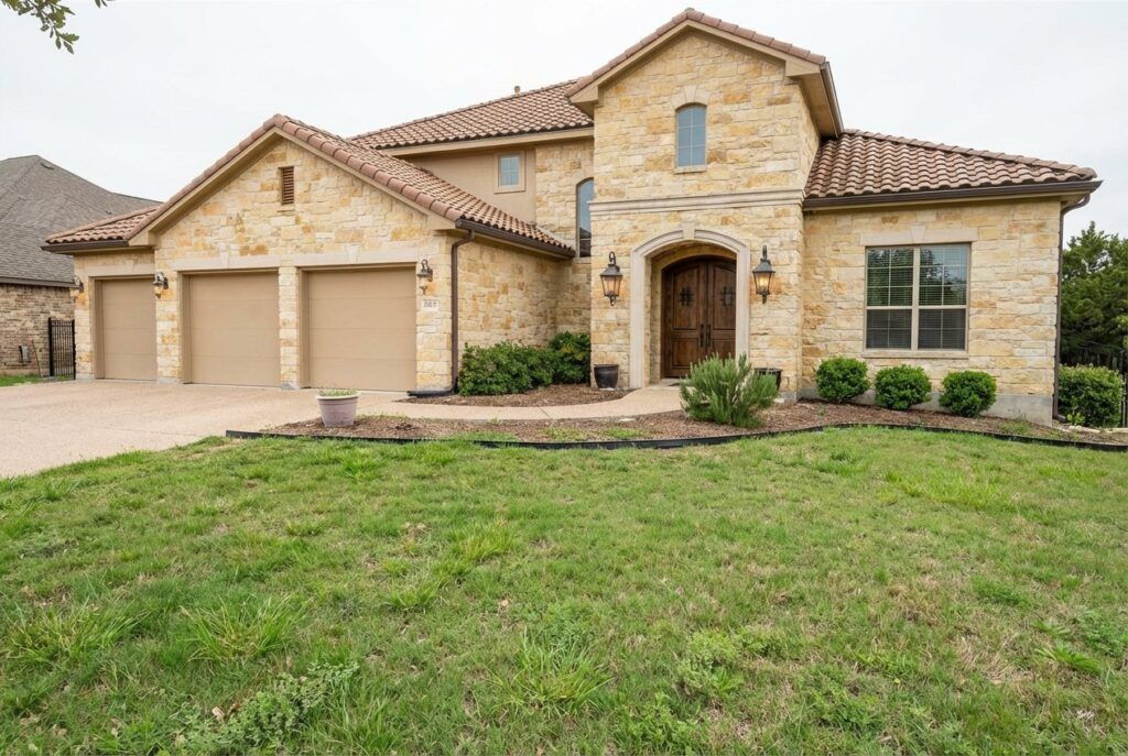 Before photo of Tuscan-style drought-tolerant landscape design with xeriscape planting beds in San Antonio